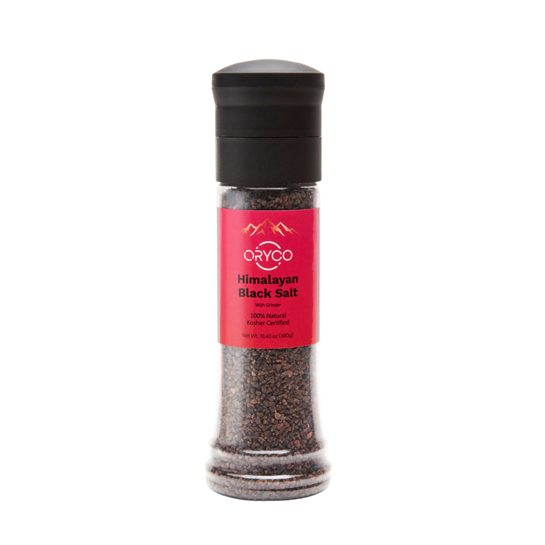 Himalayan black salt grinder with pink label on a white background