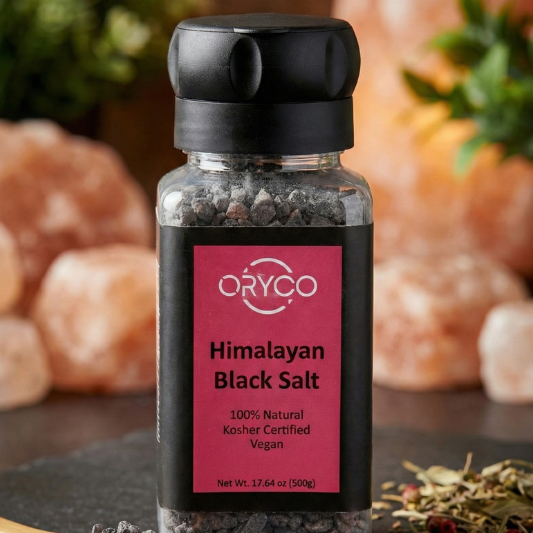 Himalayan Black Salt container with salt on a wooden spoon and around it