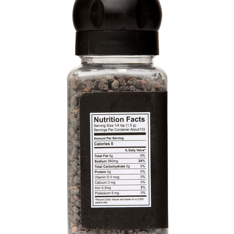 Spice jar with black lid and nutrition facts label on a white background
