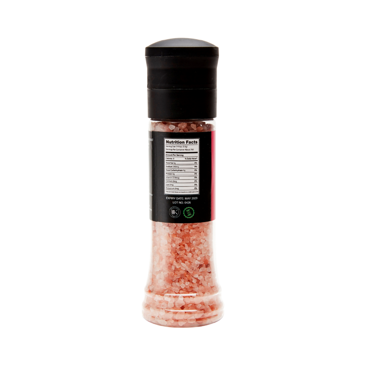 Bottle of pink Himalayan salt with a black lid on a white background