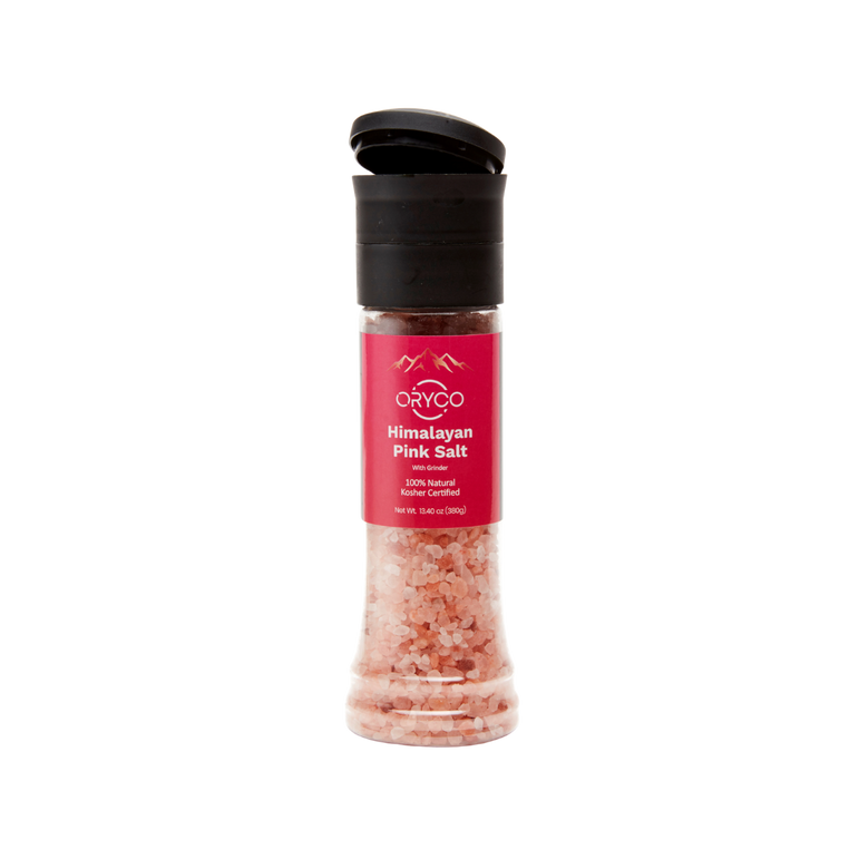Himalayan pink salt grinder with a black lid on a white background
