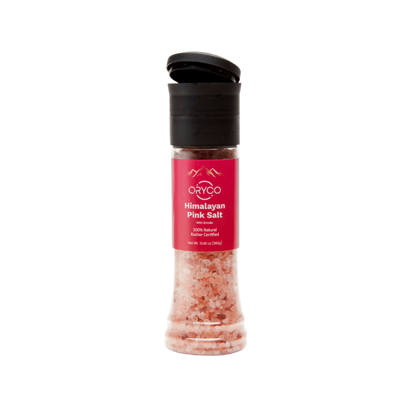 Himalayan pink salt grinder with a black lid on a white background
